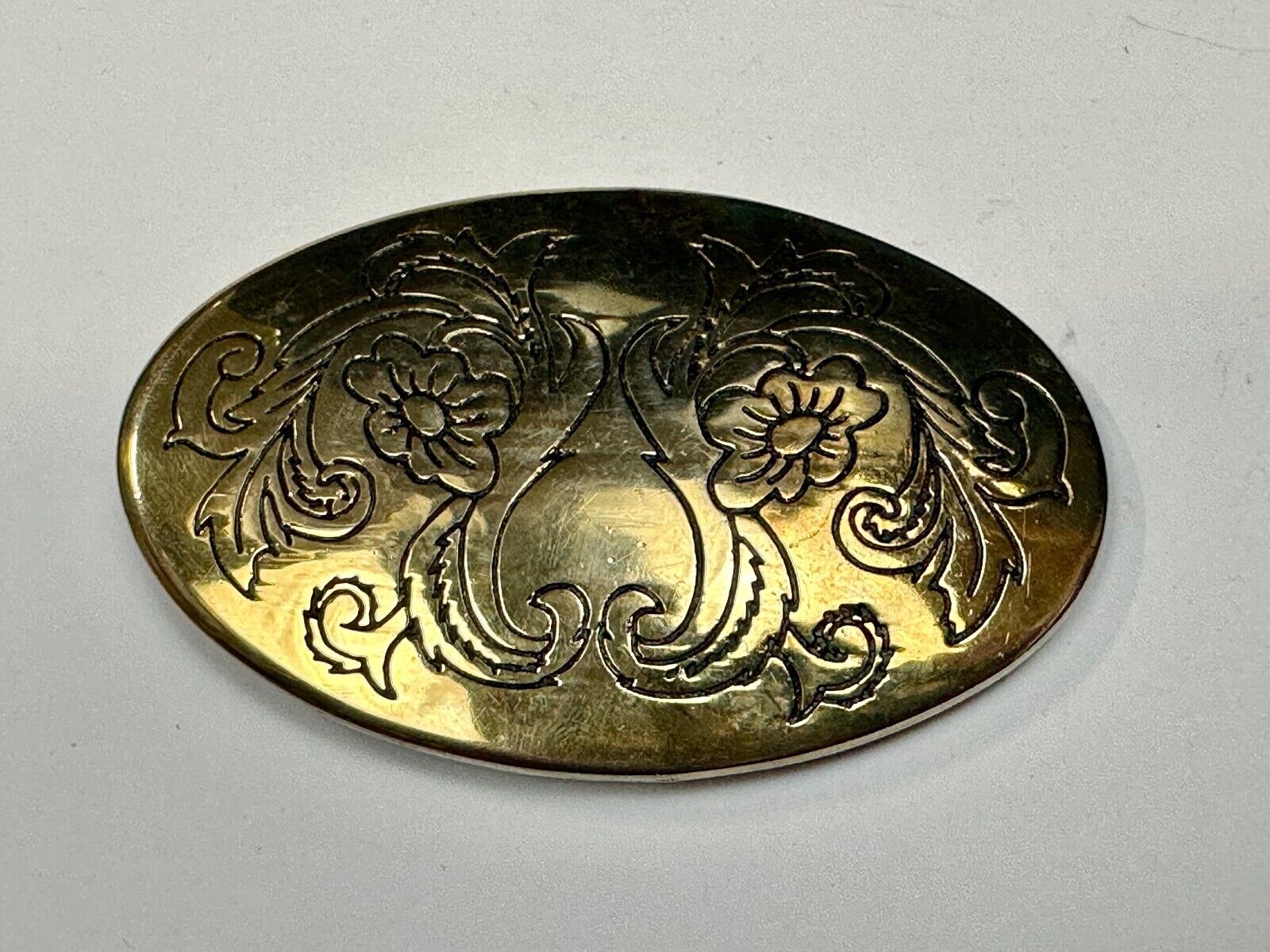 Antique? Engraved flower swirl pattern on gold color oval belt buckle