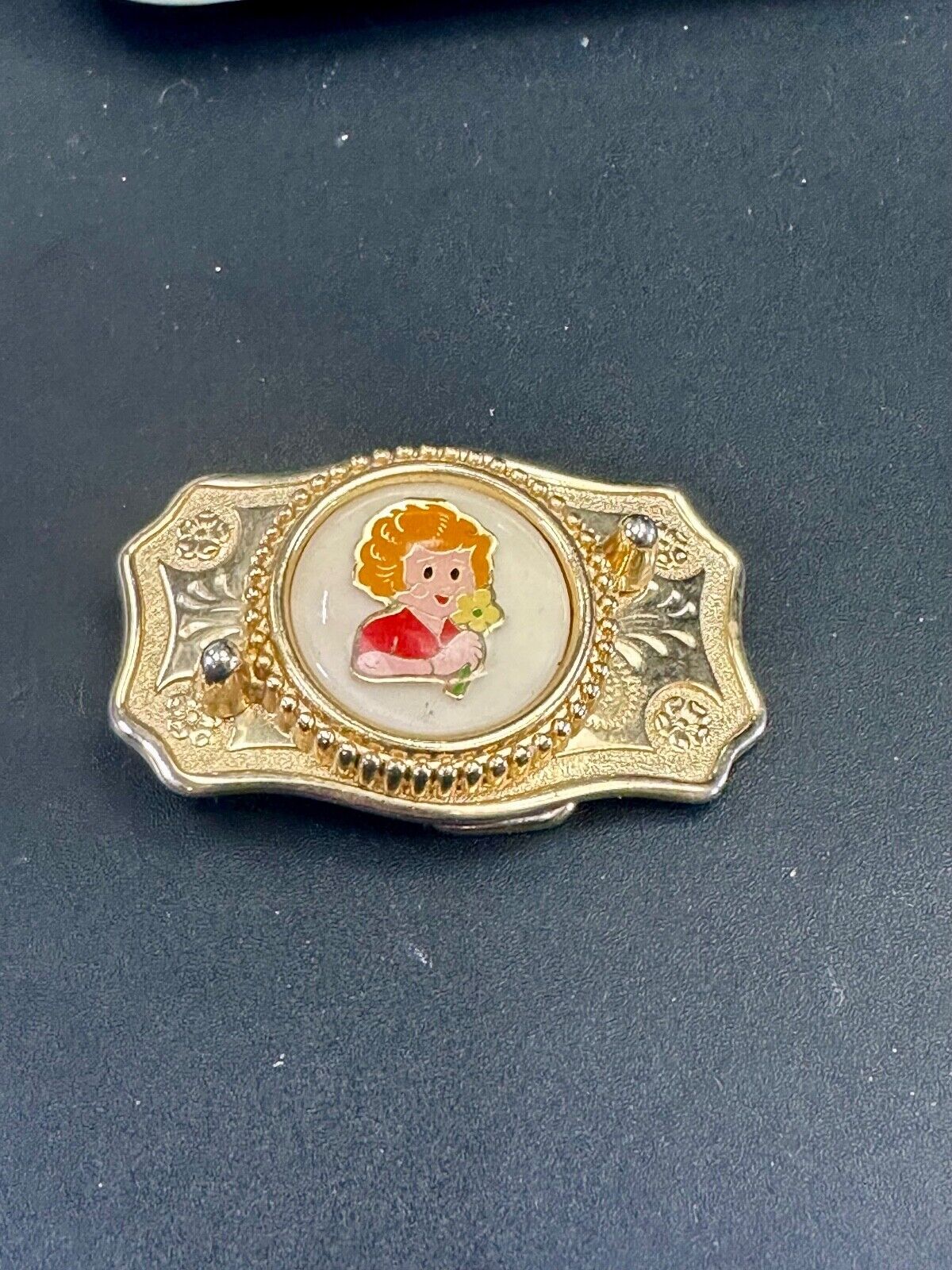 Adorable red headed girl with flower as centerpiece on western belt buckle