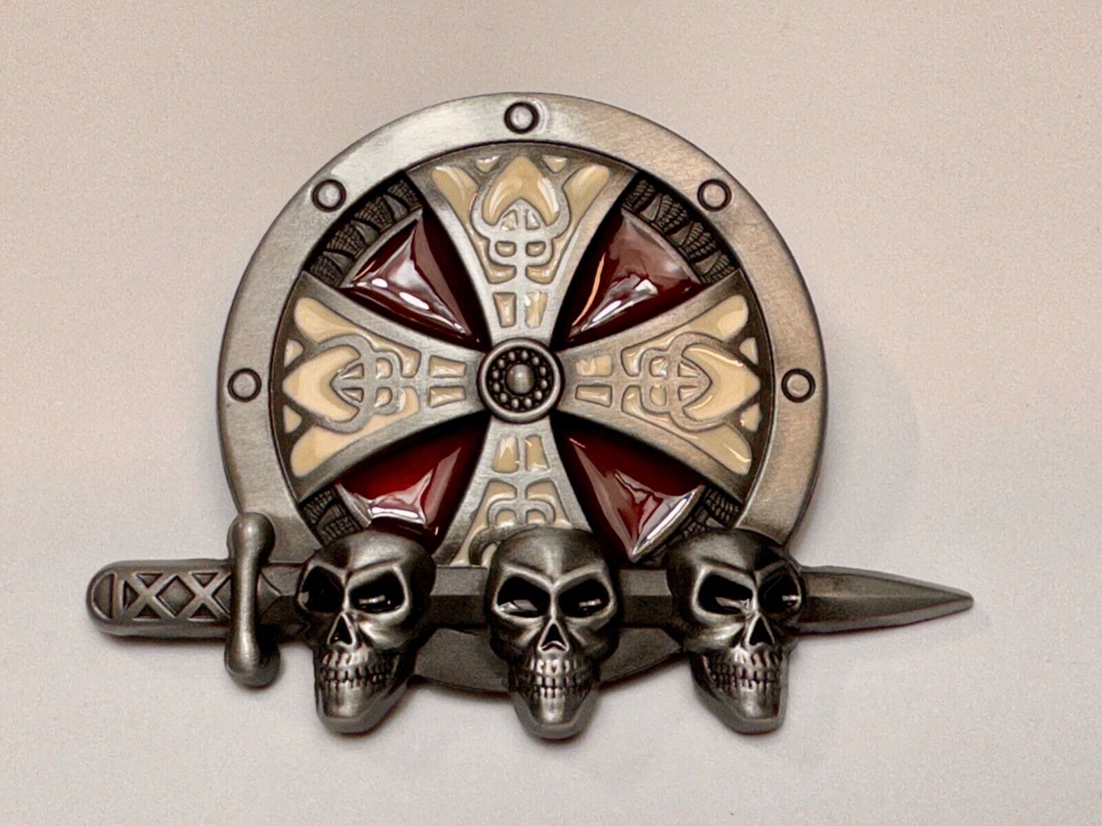 Three skulls with sword through heads on Iron Cross round NOS belt buckle